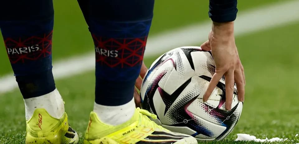 Player preparing to take a free kick on field
