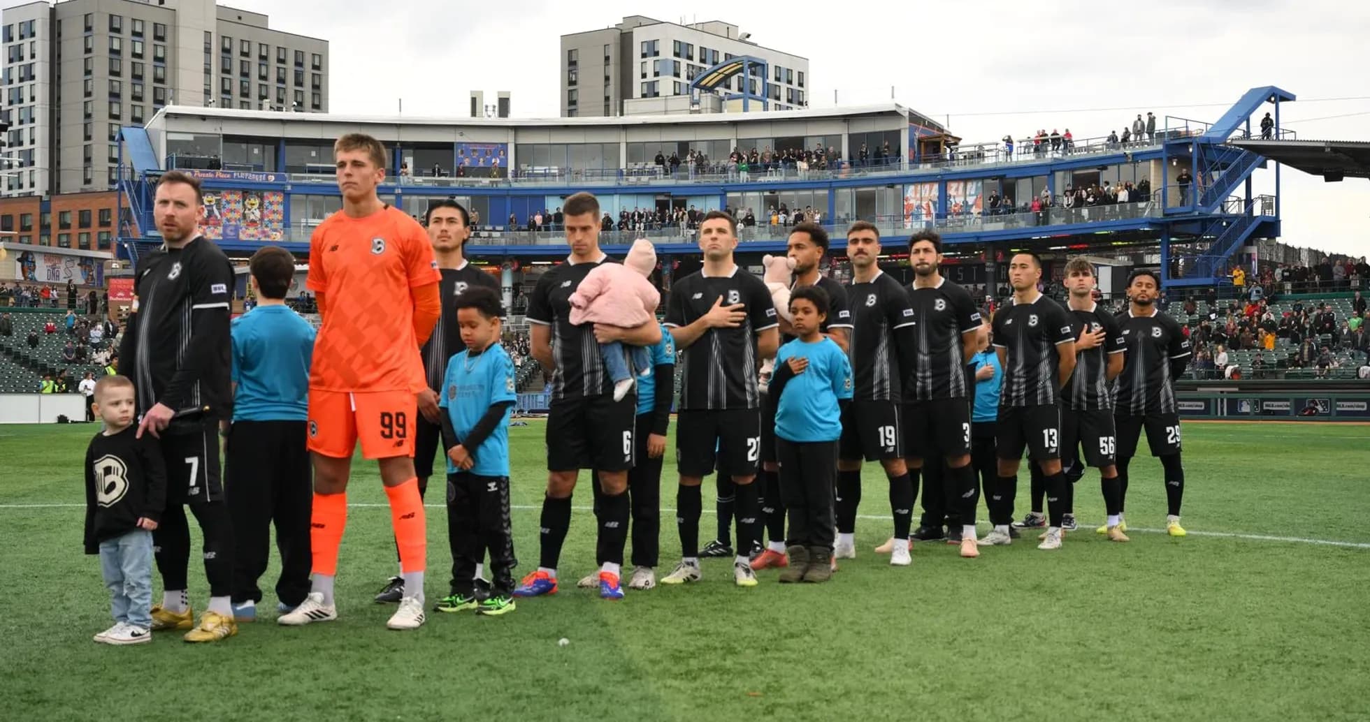 Players standing during national anthem before match