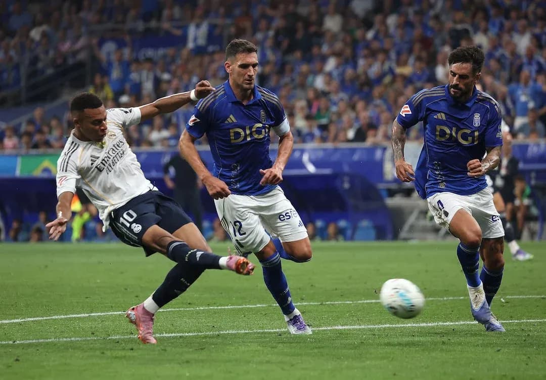 Real Madrid player attempting to shoot on goal