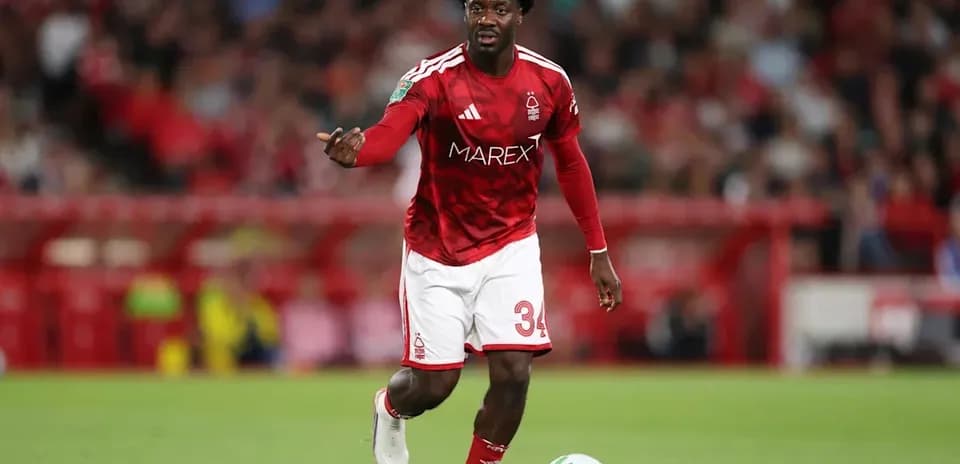 Player in red kit controlling ball during match