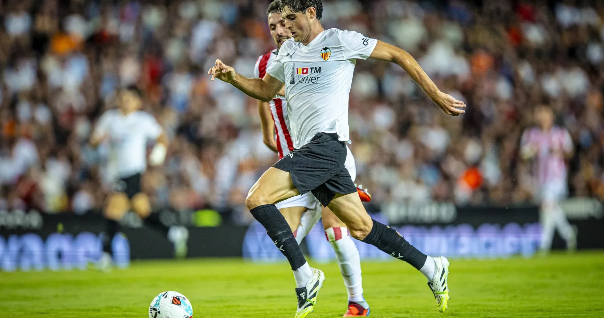 Valencia player dribbling during La Liga match