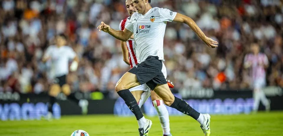 Valencia player dribbling during La Liga match