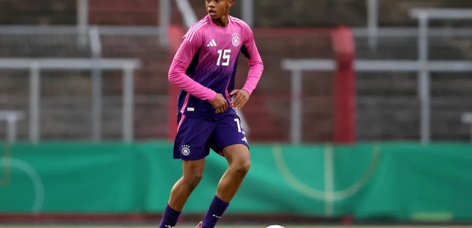Player in pink and purple kit during training session