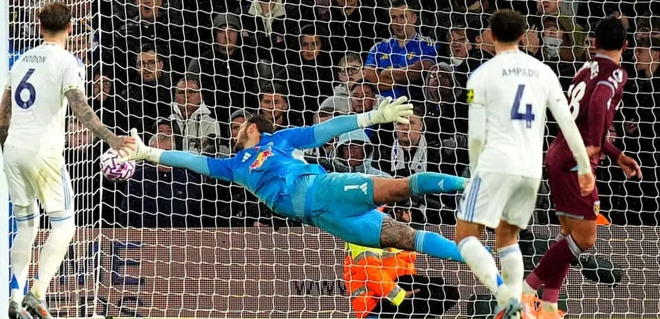 Goalkeeper diving to save a shot during match