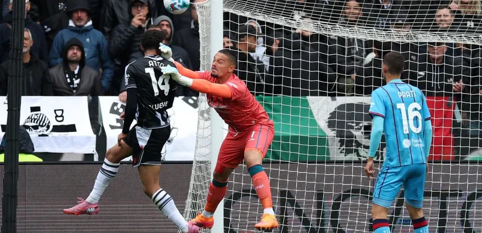 Goalkeeper challenges player during Serie A match