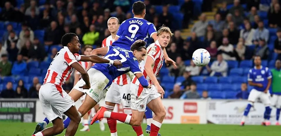 Player jumping to head the ball during match