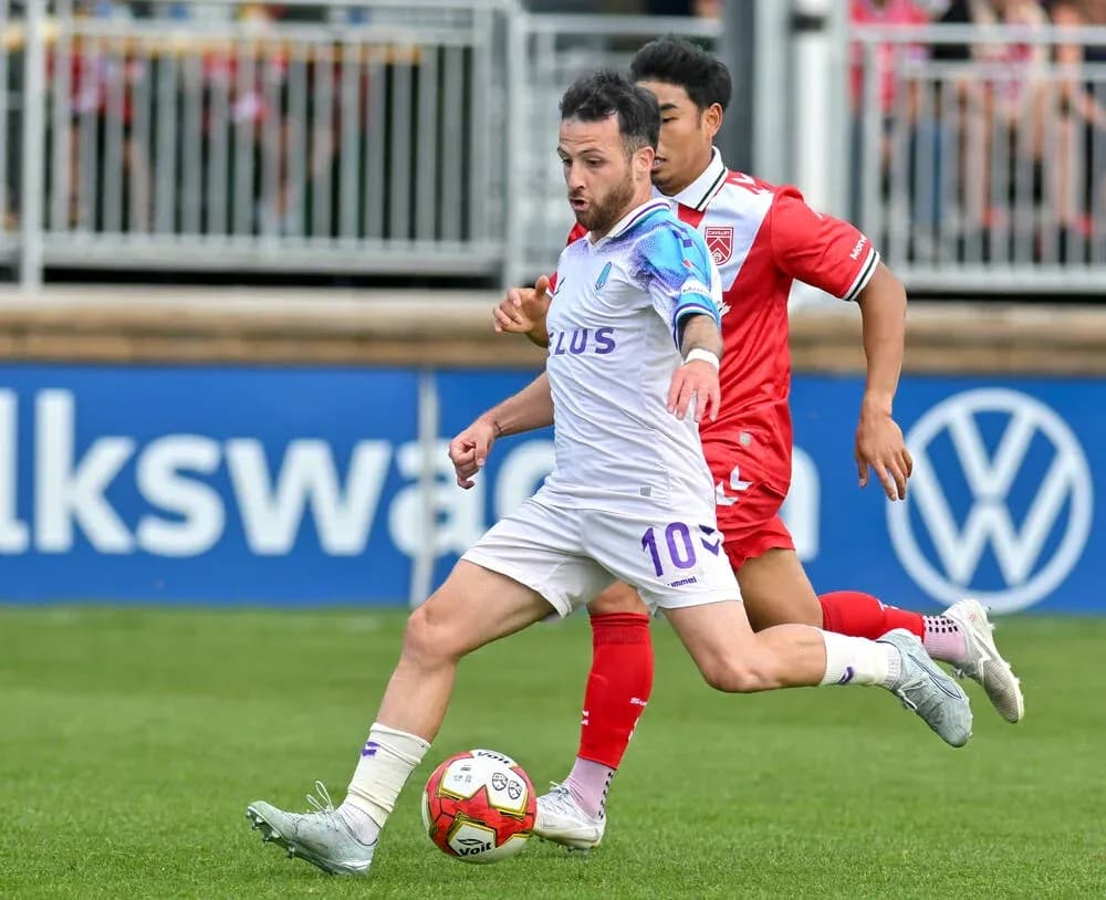 Player dribbling the ball during Cavalry FC match