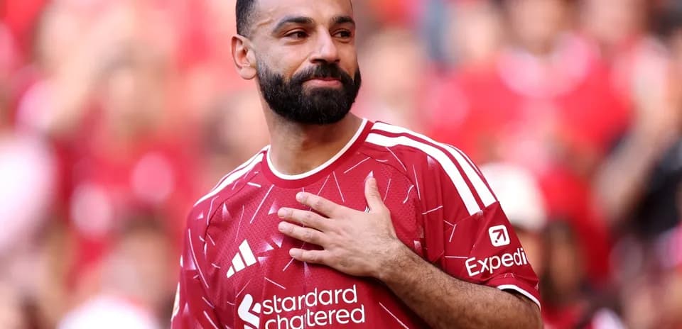 Player in red jersey with hand on chest