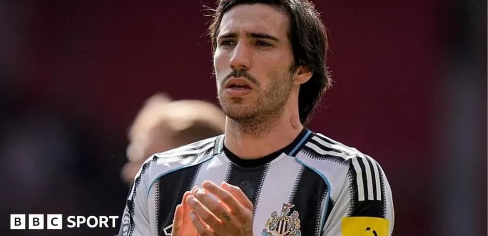 Player applauding on the field in Newcastle kit