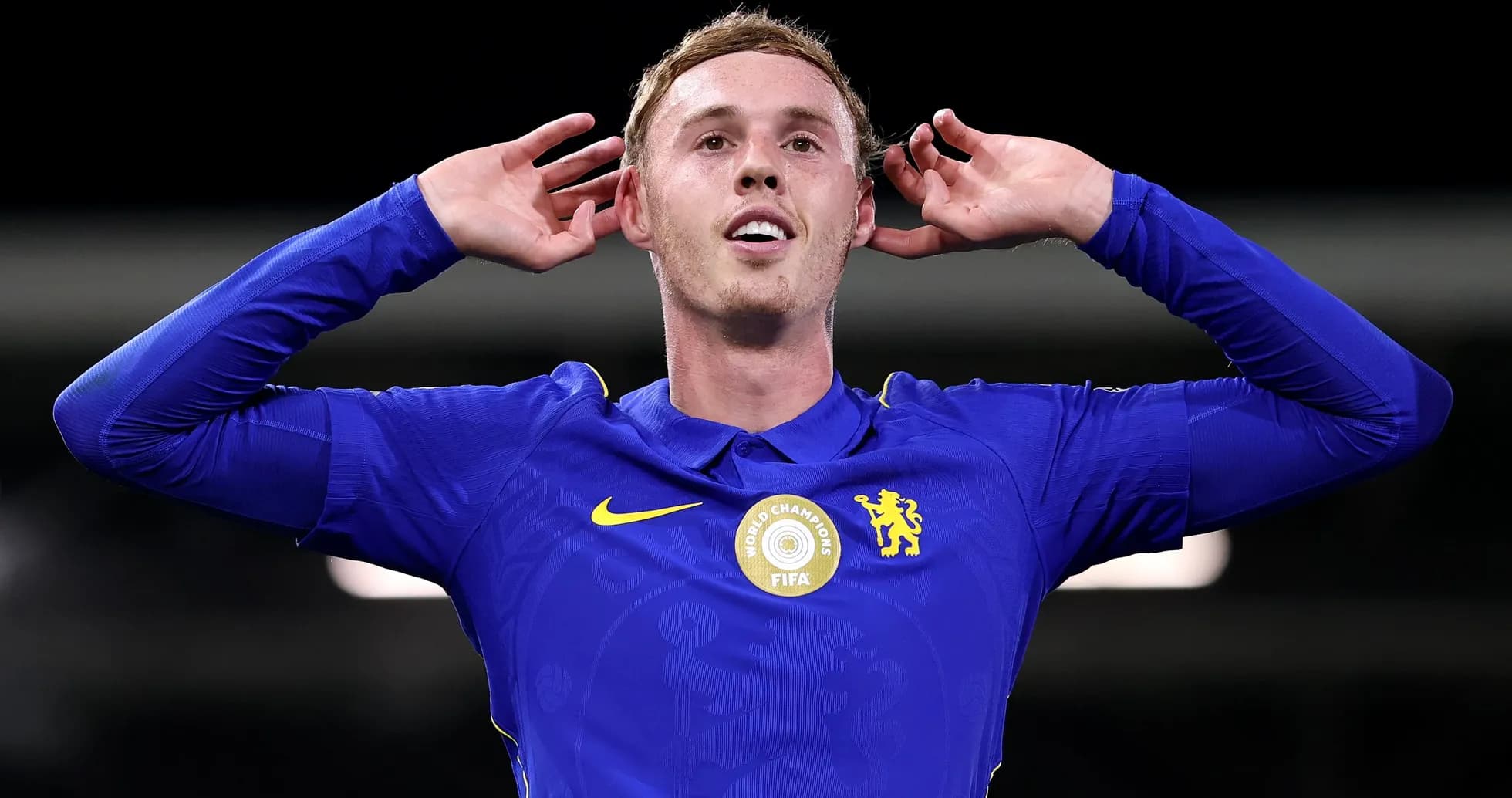 Player celebrating with hands on ears in blue jersey