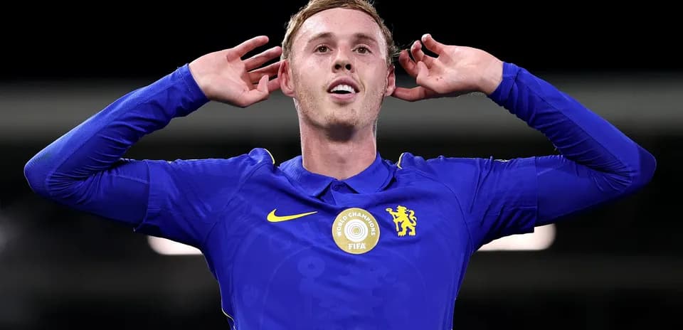 Player celebrating with hands on ears in blue jersey