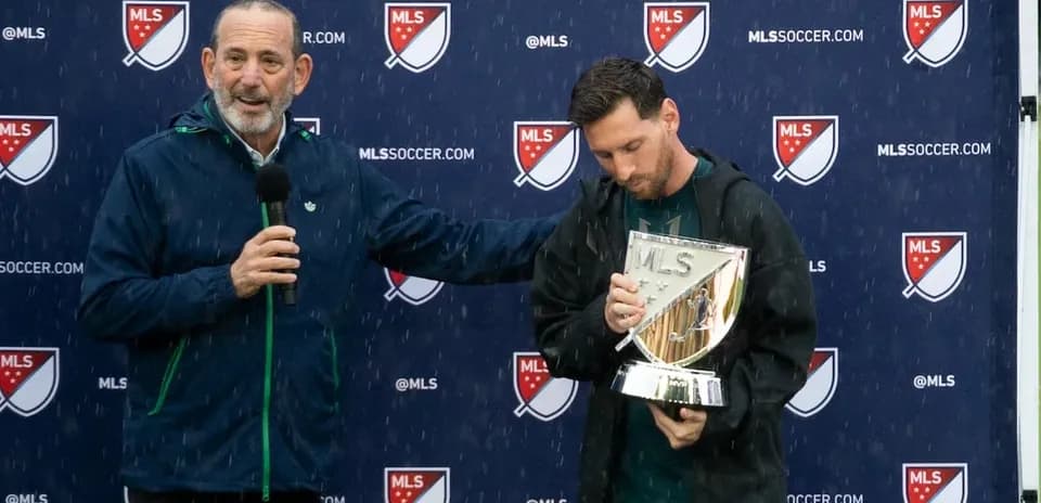 Official presenting award to player during rainy event