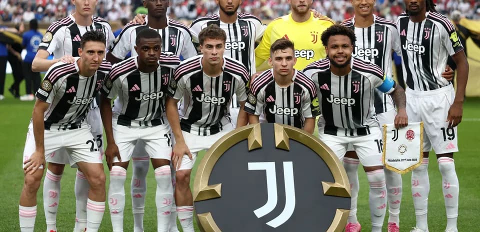 Juventus team posing with club emblem and banner