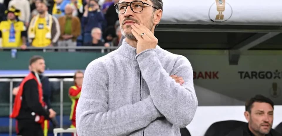 Coach observing match from sidelines during game