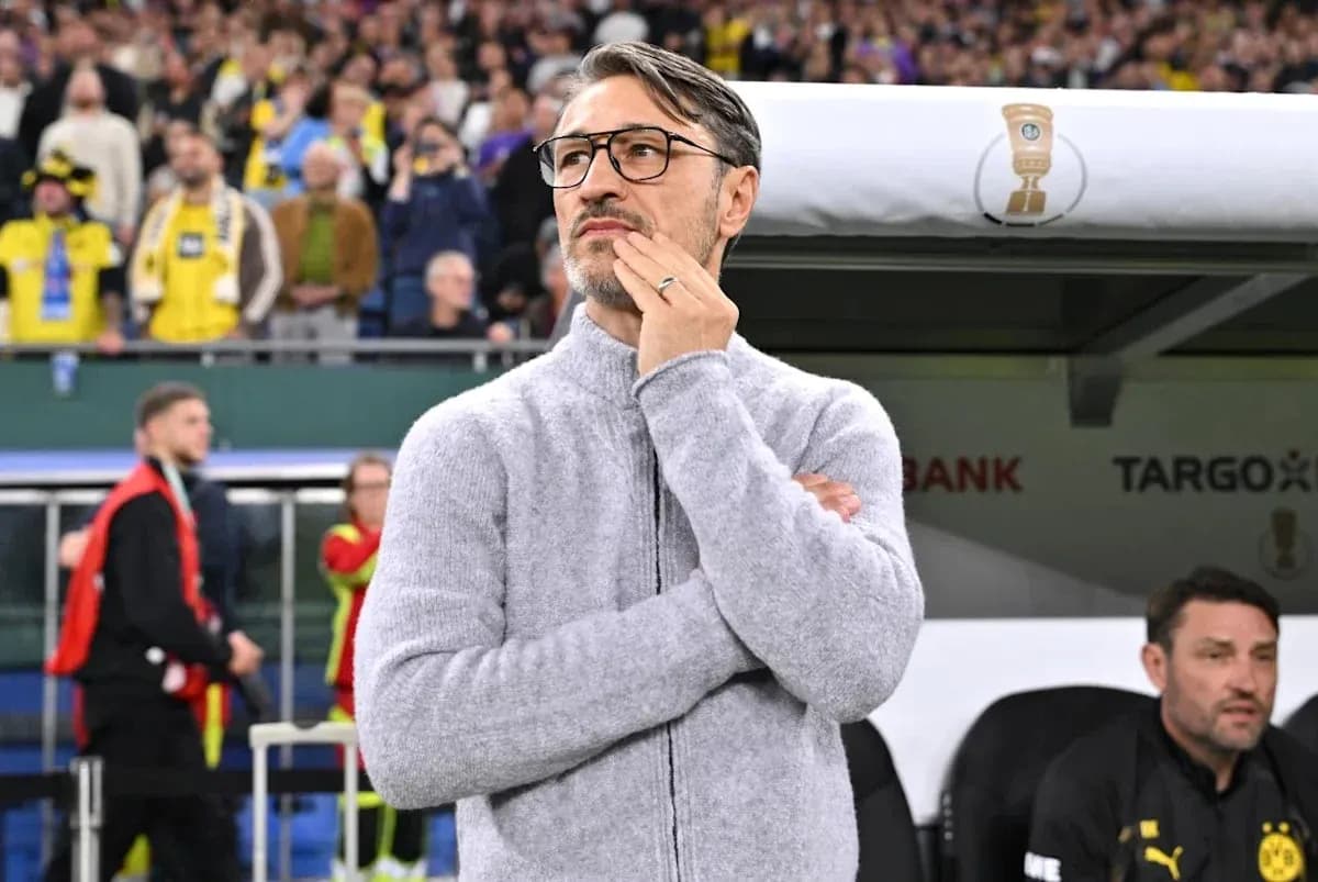 Coach observing match from sidelines during game