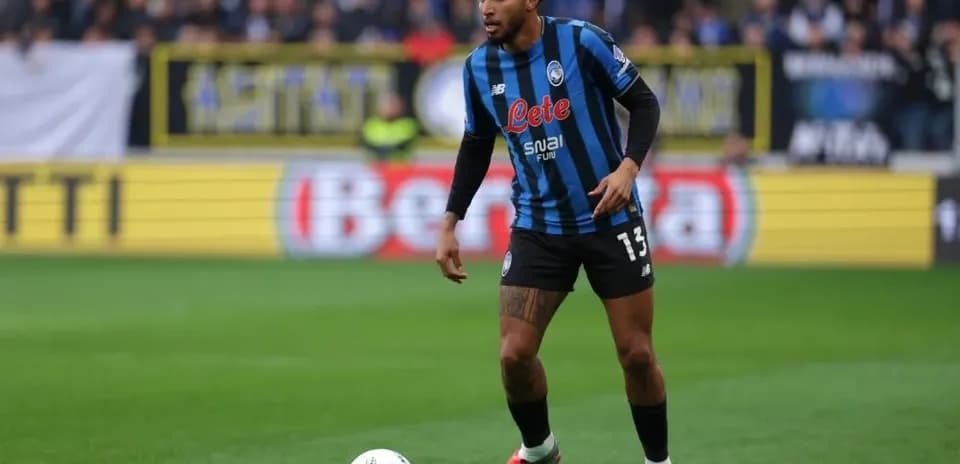 Player in blue and black kit with ball during match