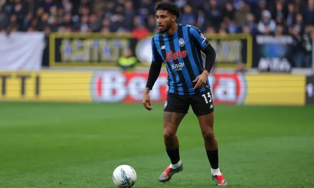 Player in blue and black kit with ball during match