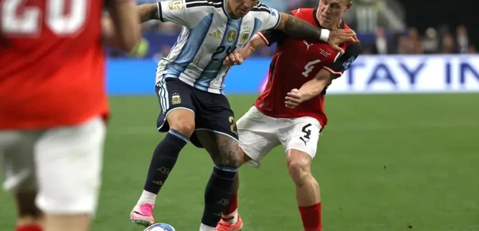 Argentinian player dribbling past opponent during match