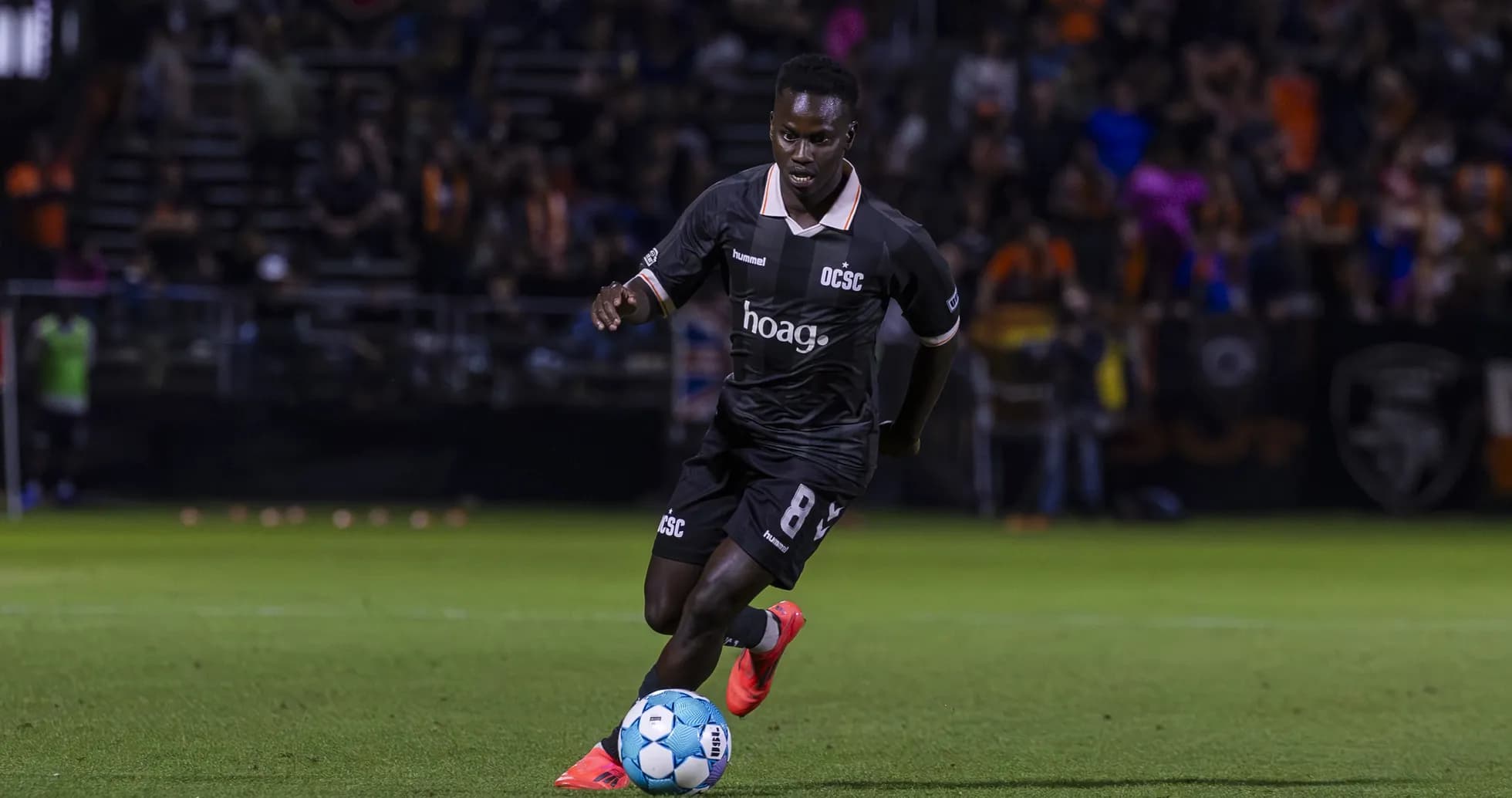 Player from Orange County SC dribbling the ball