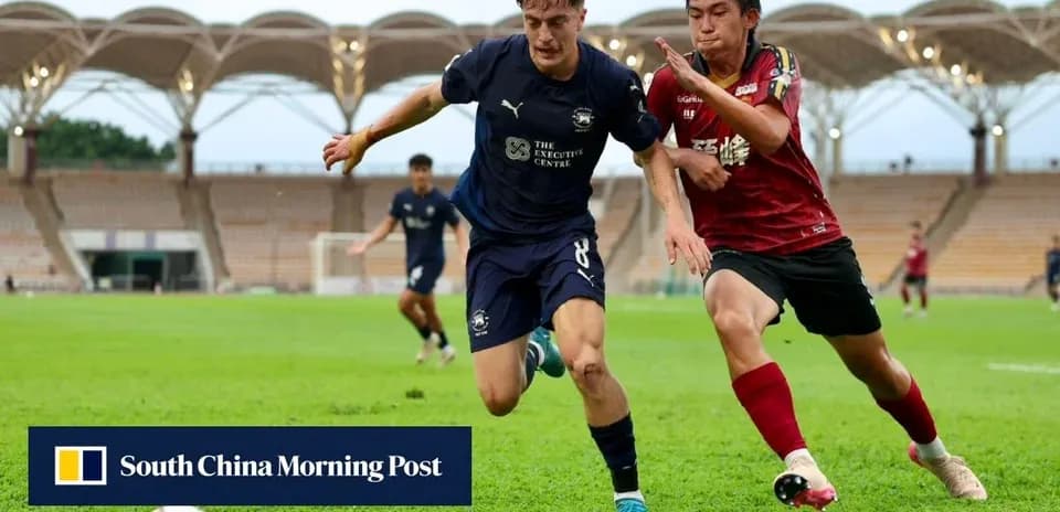 Player tackling opponent during soccer match on field