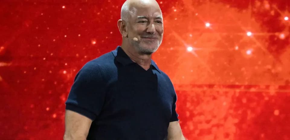 Speaker presenting against a red background