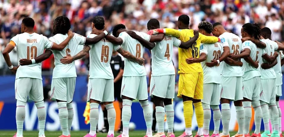 Team standing in solidarity before match kickoff