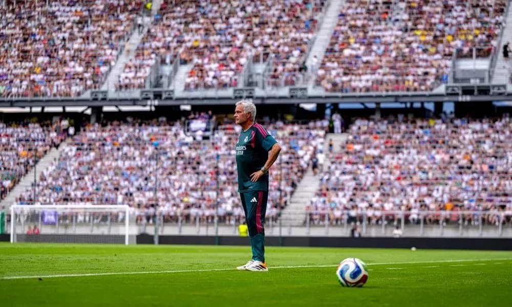Coach observing match from sideline in stadium
