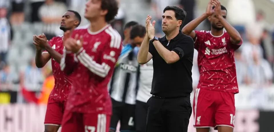 Liverpool players and coach applauding fans after match