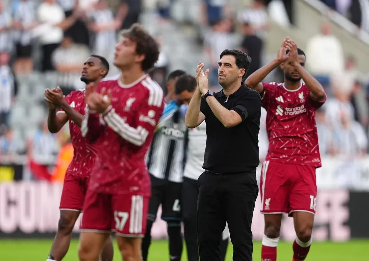 Liverpool players and coach applauding fans after match