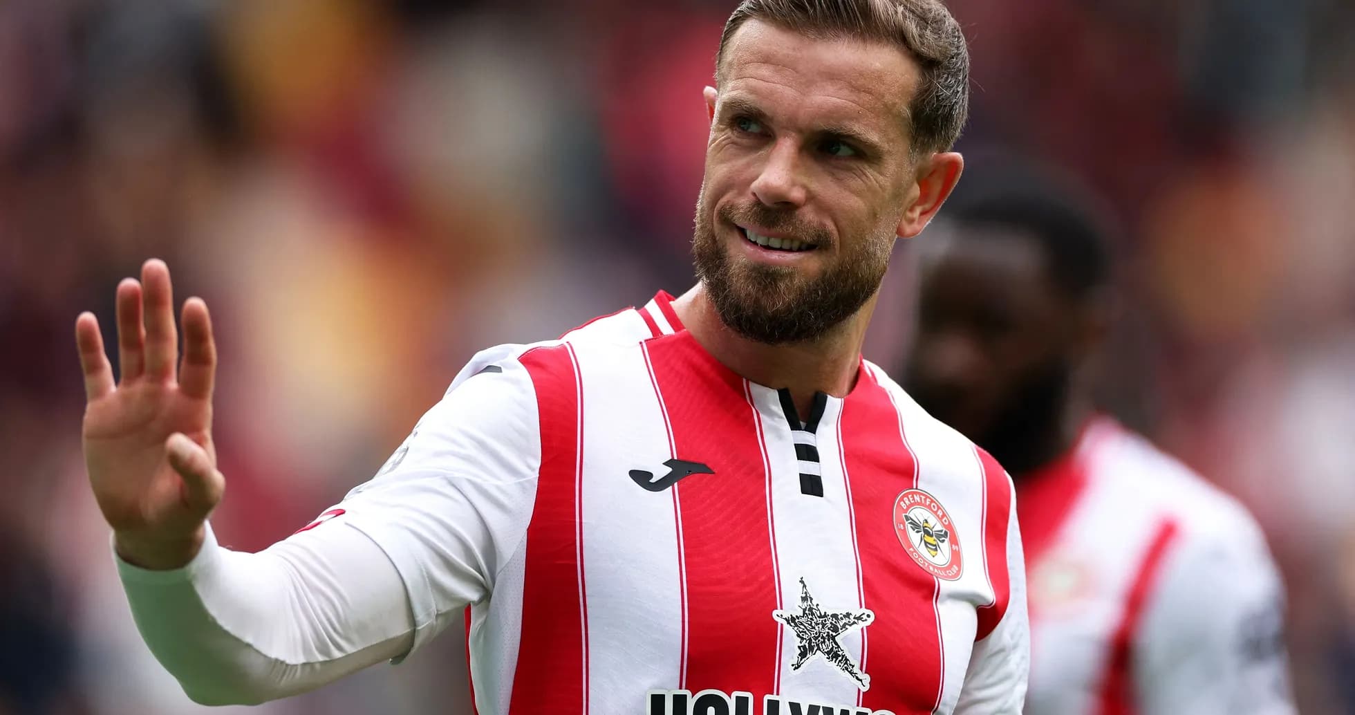 Brentford player waving during match celebration