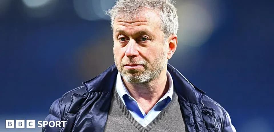 Man in a jacket at a sports venue