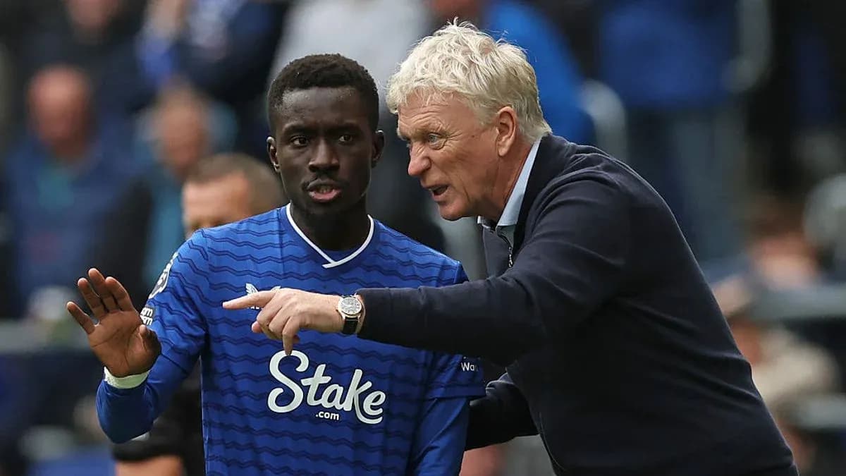 Manager giving instructions to player on pitch