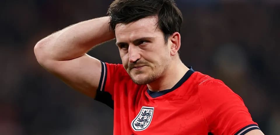 Player in red jersey looking concerned on field