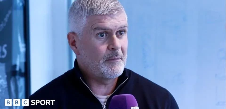 Person speaking into microphone during interview