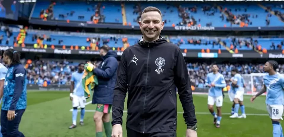 Coach walking off the pitch at Etihad Stadium