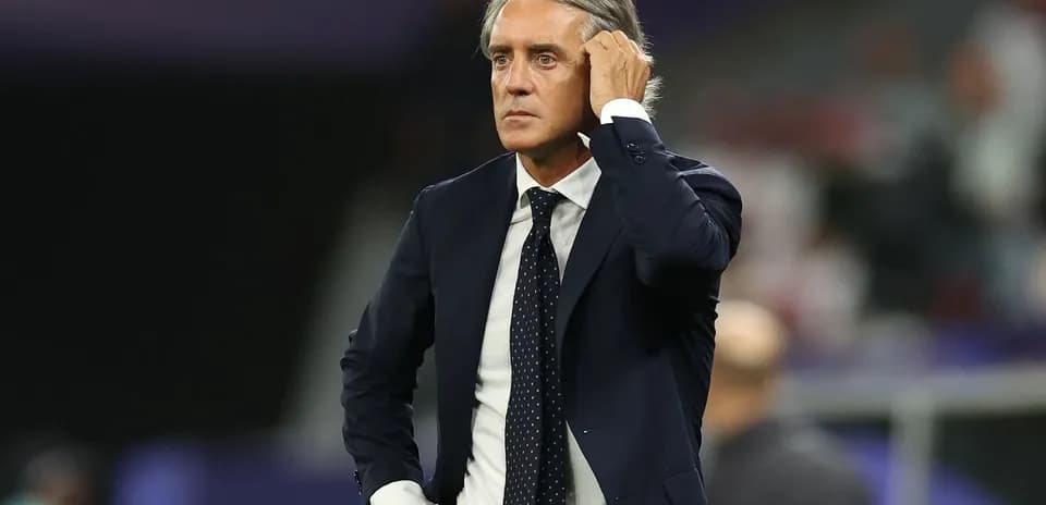 Coach observing match action on the sidelines