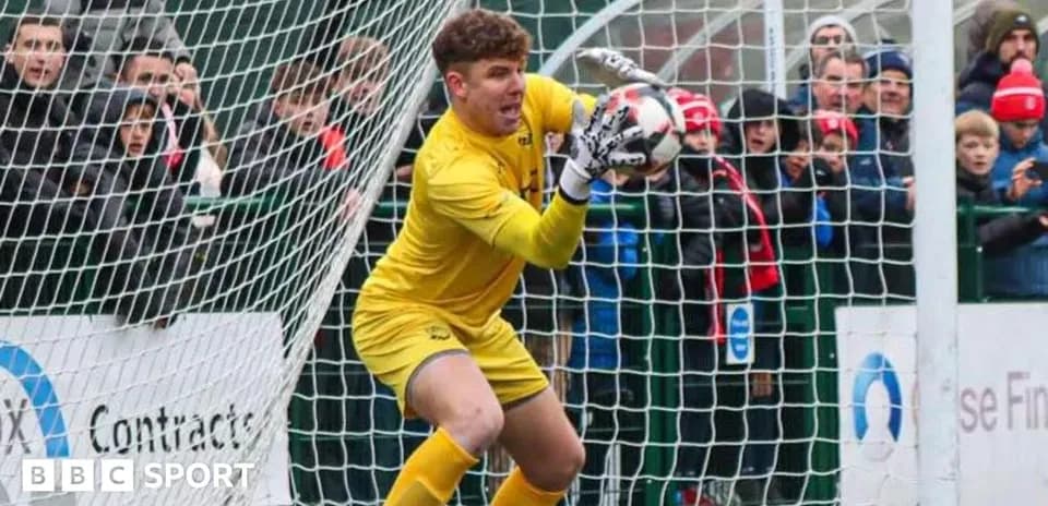 Goalkeeper making a save in front of fans