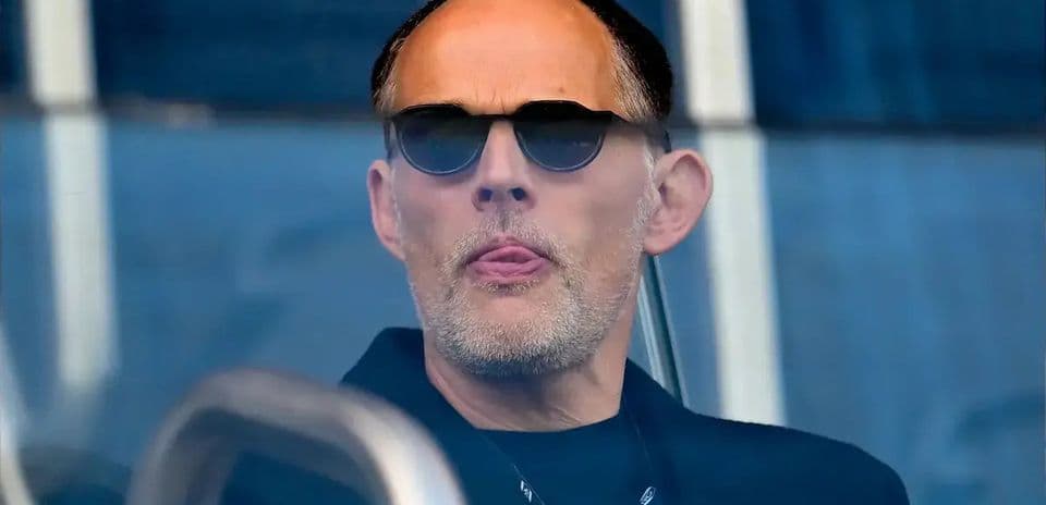 Man with sunglasses watching from a balcony