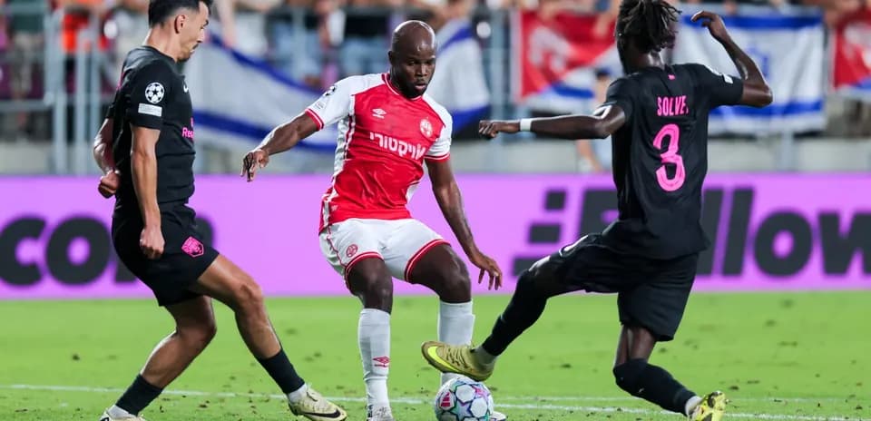 Two players contesting the ball in UEFA match