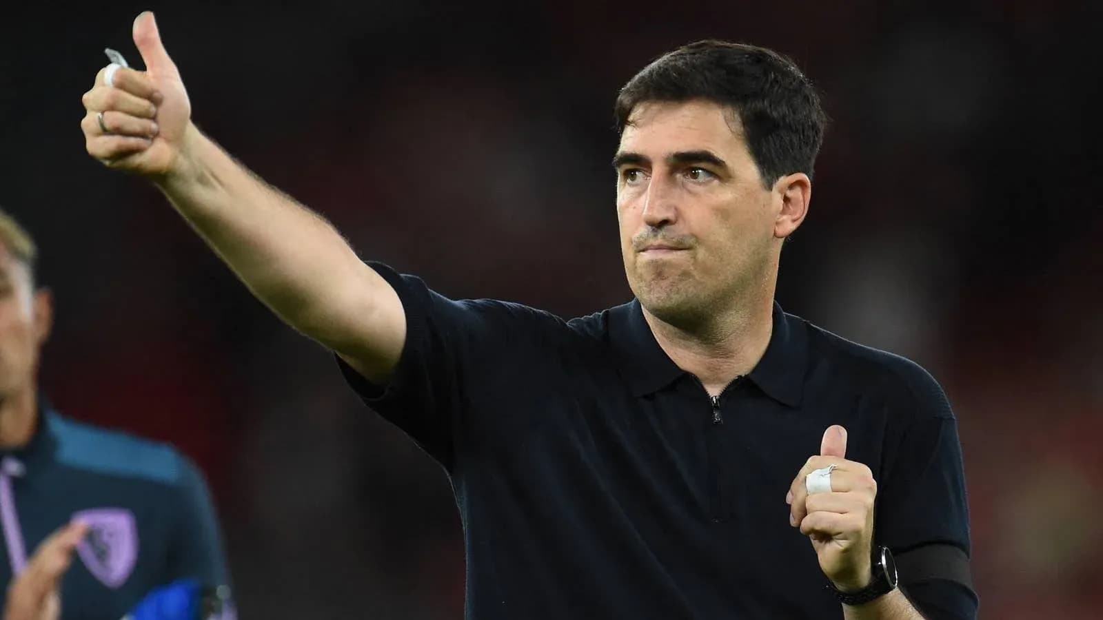 Coach giving thumbs up after match conclusion