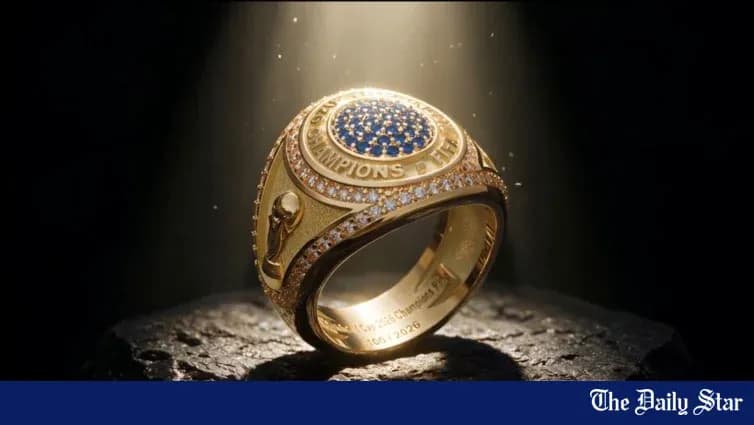 Championship ring displayed on a dark surface