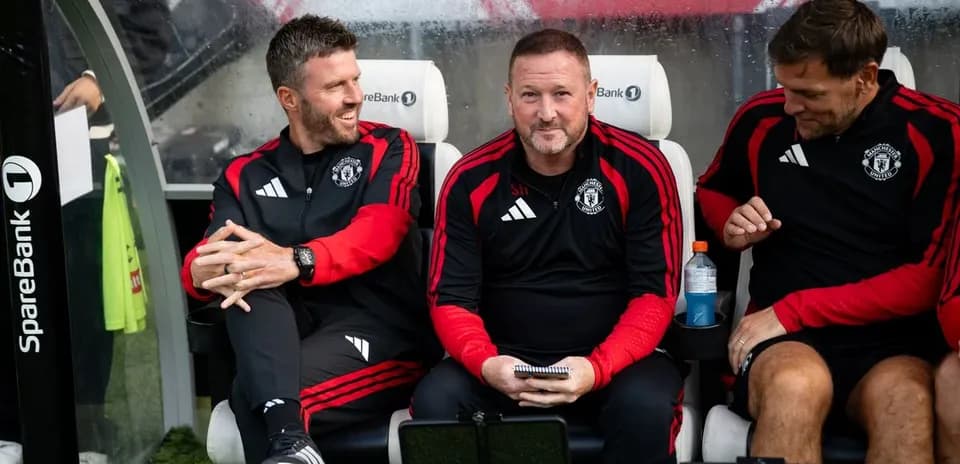 Coaching staff seated on bench during match