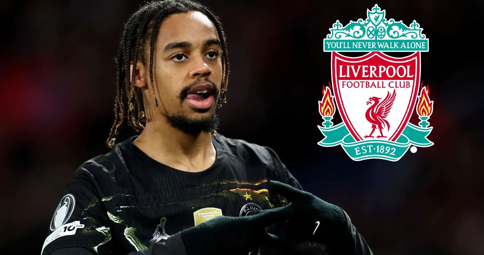 Player gesturing with Liverpool FC logo in background