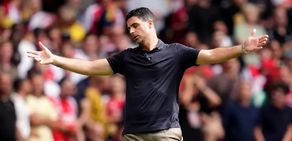 Manager gesturing towards the crowd during match
