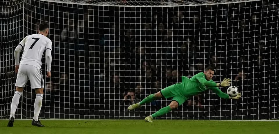 Goalkeeper saving a penalty kick during match