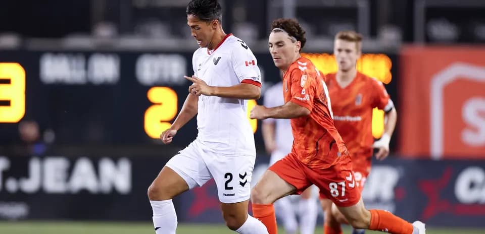 Vancouver FC player dribbling past Forge defender