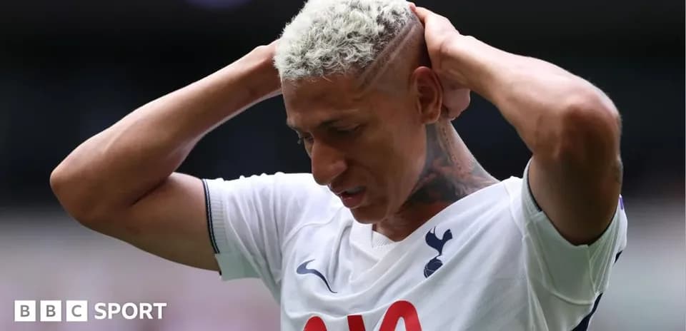 Player holding head in disappointment on field