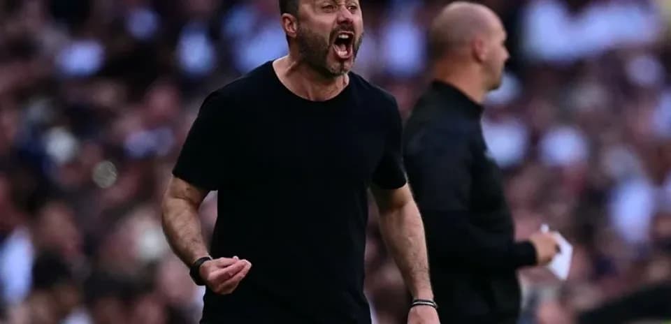 Coach celebrating passionately on the sidelines during match