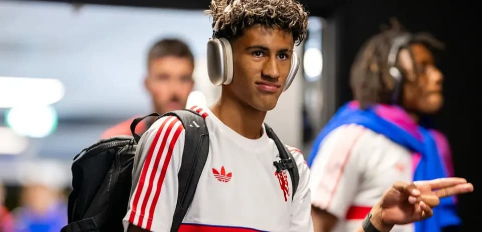 Player wearing headphones entering stadium tunnel