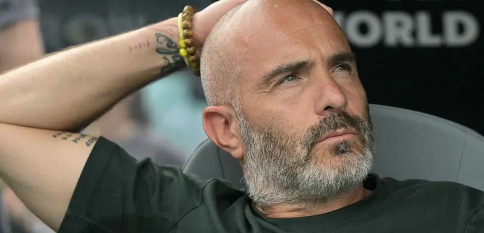 Coach sitting in dugout during a match
